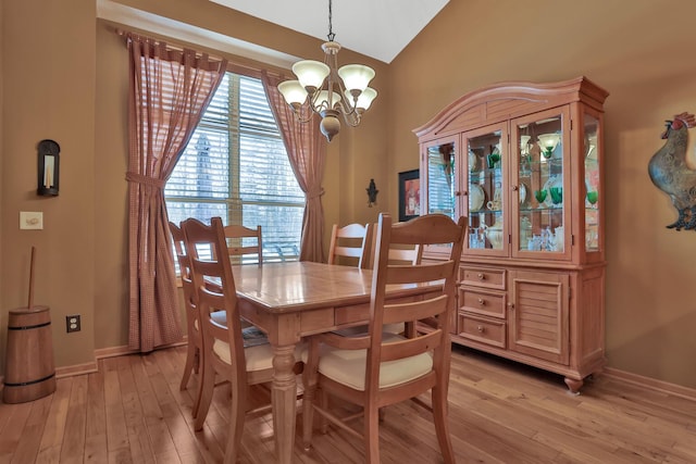 29561 Mentzer Ct, Lindstrom, MN 55045 - dining area with a chandelier, light wood-style floors, vaulted ceiling, and baseboards