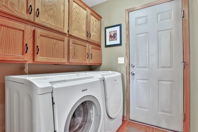29561 Mentzer Ct, Lindstrom, MN 55045 - washroom with separate washer and dryer, cabinet space, and light wood-style flooring