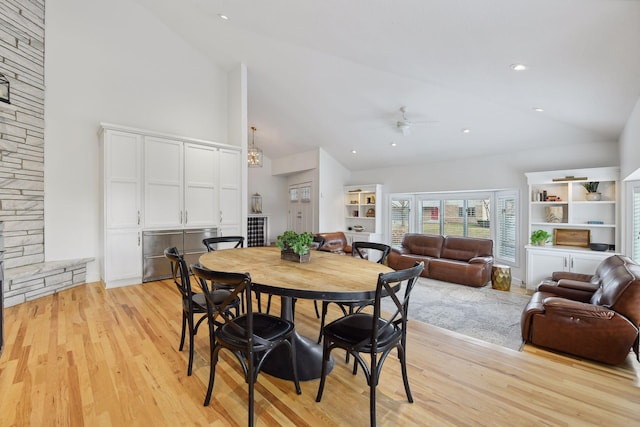 dining space featuring light wood-style flooring, recessed lighting, a ceiling fan, and high vaulted ceiling