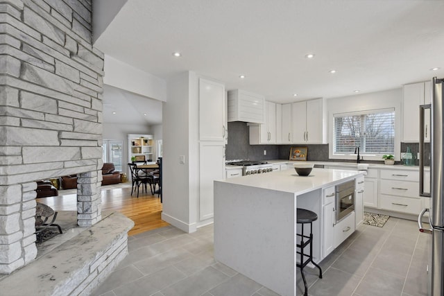 kitchen with decorative backsplash, plenty of natural light, appliances with stainless steel finishes, and a kitchen island