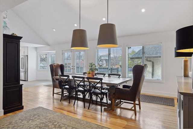 dining space with light wood finished floors, baseboards, and a wealth of natural light