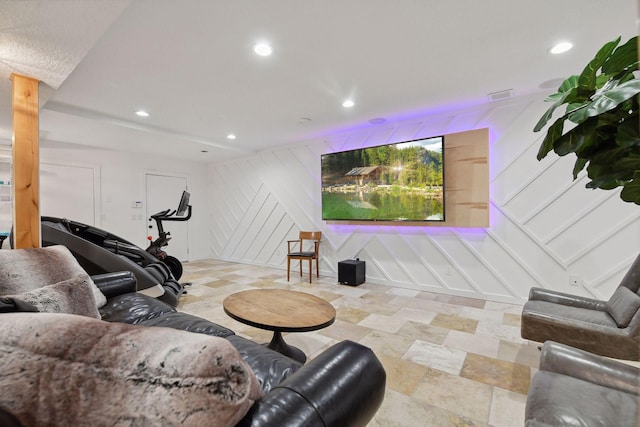 living room with recessed lighting, stairs, and a decorative wall