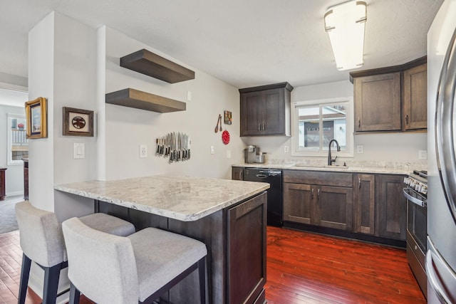 16139 Northwood Rd NW, Prior Lake, MN 55372 - kitchen featuring a sink, stainless steel appliances, dark wood-style floors, a breakfast bar area, and dark brown cabinetry