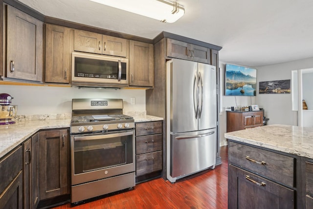 16139 Northwood Rd NW, Prior Lake, MN 55372 - kitchen featuring stainless steel appliances, dark wood finished floors, light stone counters, and dark brown cabinetry