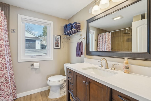 16139 Northwood Rd NW, Prior Lake, MN 55372 - full bath with wood finished floors, baseboards, toilet, vanity, and a shower with curtain