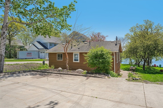 16139 Northwood Rd NW, Prior Lake, MN 55372 - view of home's exterior featuring a shingled roof and a lawn