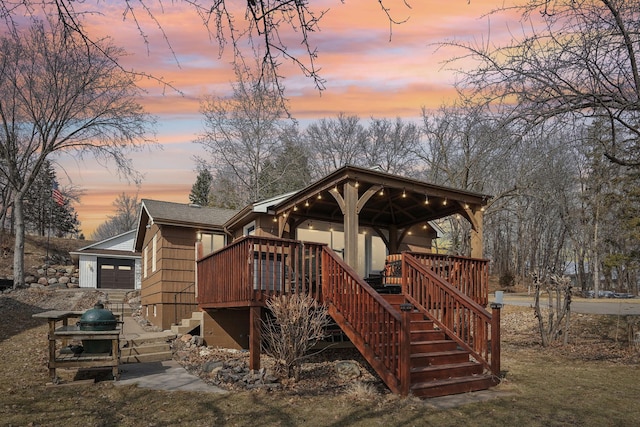16139 Northwood Rd NW, Prior Lake, MN 55372 - back of house at dusk featuring stairs, a shingled roof, and a wooden deck