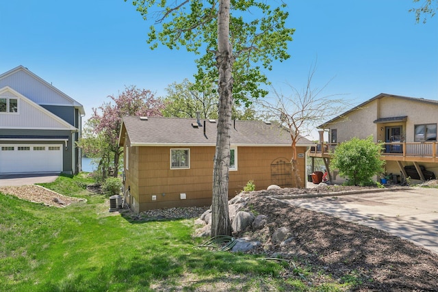 16139 Northwood Rd NW, Prior Lake, MN 55372 - back of house featuring a lawn, central AC unit, and a shingled roof