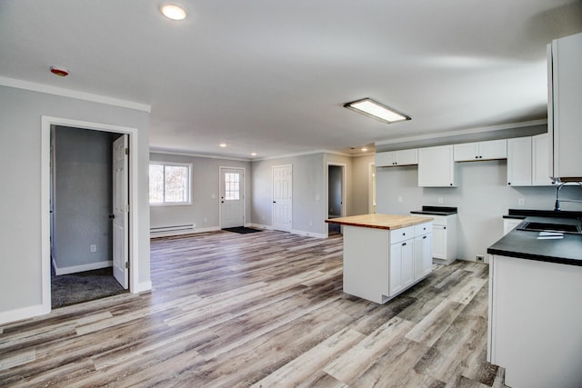 33916 Twin Oaks Loop, Motley, MN 56466 - kitchen featuring butcher block countertops, crown molding, baseboard heating, a sink, and recessed lighting