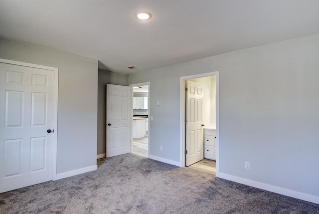 33916 Twin Oaks Loop, Motley, MN 56466 - unfurnished bedroom with light carpet, baseboards, and connected bathroom