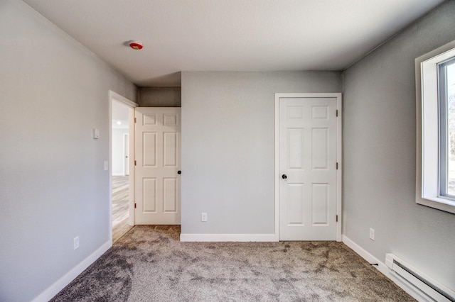 33916 Twin Oaks Loop, Motley, MN 56466 - unfurnished bedroom featuring a baseboard heating unit, carpet flooring, and baseboards