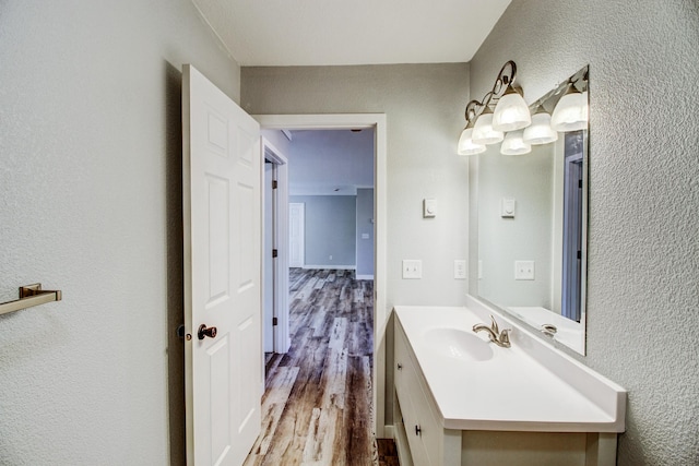 33916 Twin Oaks Loop, Motley, MN 56466 - bathroom with a textured wall, vanity, and wood finished floors