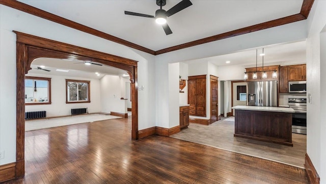 741 Riverside Rd, Holdingford, MN 56340 - kitchen with stainless steel appliances, a ceiling fan, radiator heating unit, hardwood / wood-style floors, and crown molding