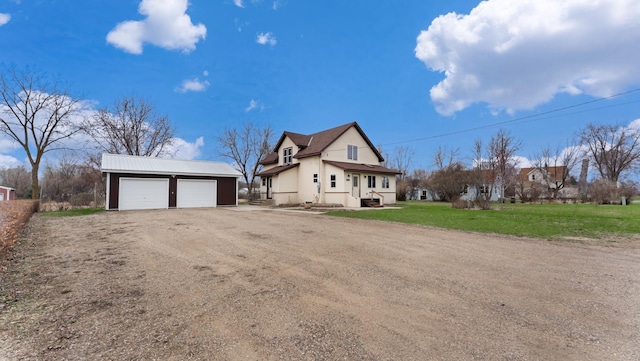 741 Riverside Rd, Holdingford, MN 56340 - view of front facade with dirt driveway, an outbuilding, and a front lawn