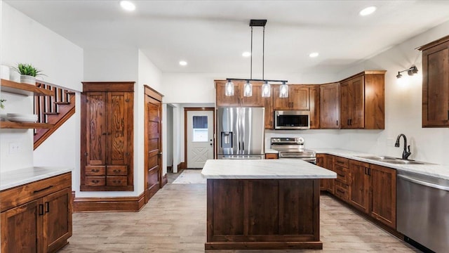 741 Riverside Rd, Holdingford, MN 56340 - kitchen with appliances with stainless steel finishes, a sink, light wood-style flooring, light countertops, and decorative light fixtures