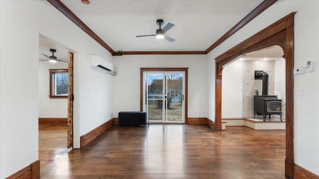 741 Riverside Rd, Holdingford, MN 56340 - spare room featuring ceiling fan, radiator heating unit, a wall mounted air conditioner, wood finished floors, and ornamental molding