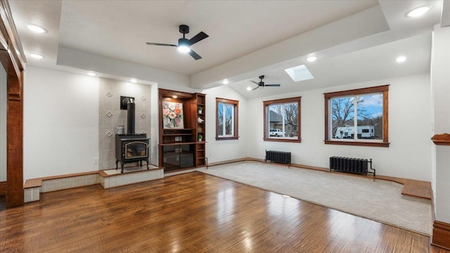 741 Riverside Rd, Holdingford, MN 56340 - home theater room with radiator heating unit, ceiling fan, vaulted ceiling, a skylight, and wood finished floors