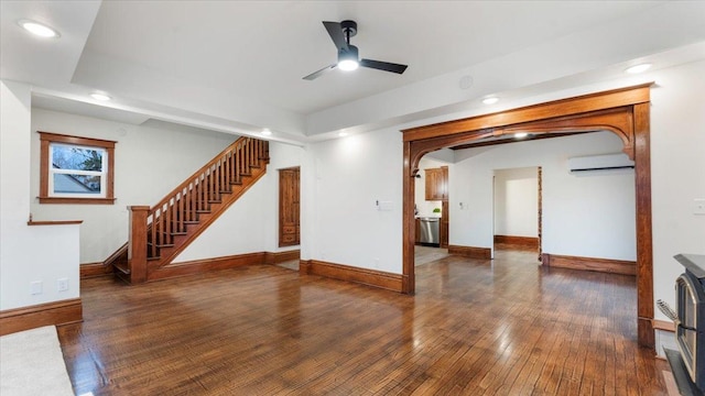 741 Riverside Rd, Holdingford, MN 56340 - unfurnished living room featuring a wall mounted air conditioner, a ceiling fan, hardwood / wood-style floors, stairs, and baseboards