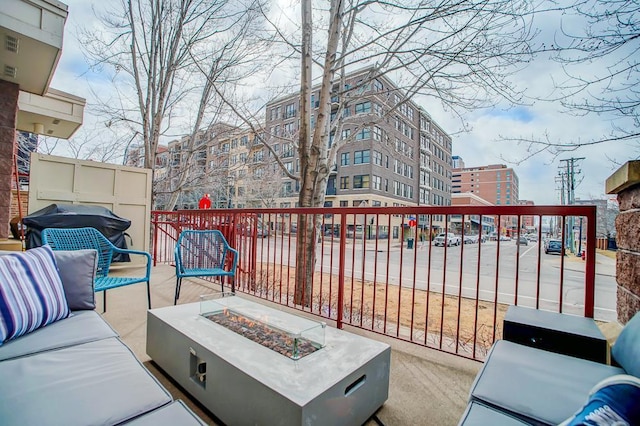 500 2nd St Unit 102, Minneapolis, MN 55401 - view of patio / terrace with an outdoor living space with a fire pit, a balcony, and a grill