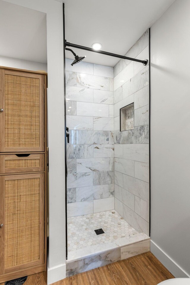 full bath featuring baseboards, a stall shower, recessed lighting, and wood finished floors