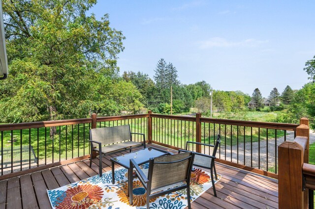 wooden deck with an outdoor living space