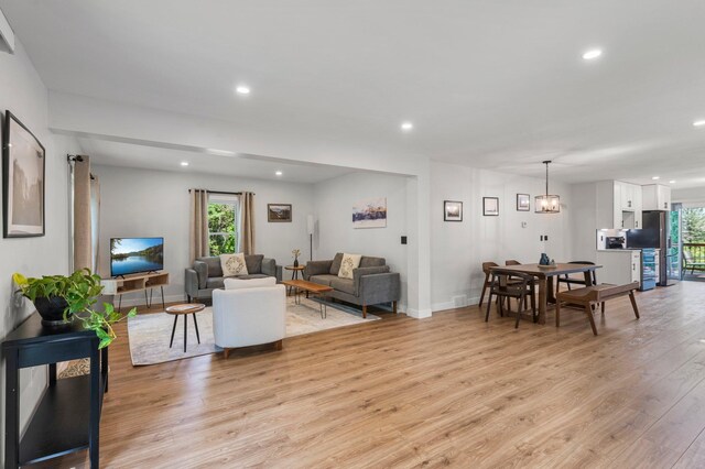 living area with light wood-style floors, recessed lighting, and a wealth of natural light