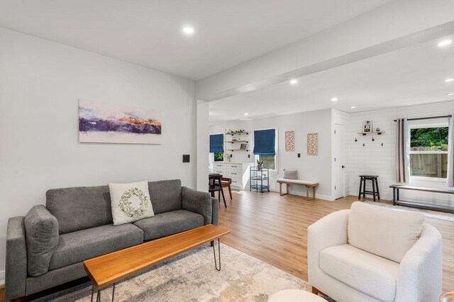 living area with recessed lighting, light wood finished floors, and baseboards
