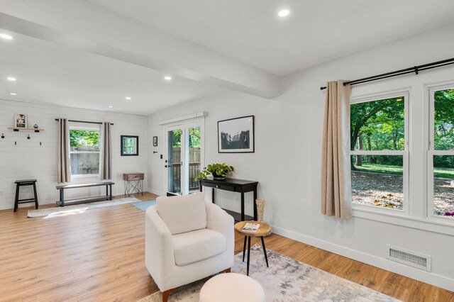 living area with recessed lighting, baseboards, visible vents, and wood finished floors