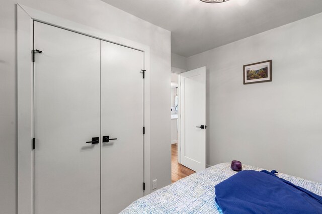 bedroom with a closet and light wood-type flooring