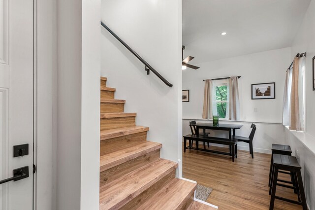 stairway featuring recessed lighting, a ceiling fan, and wood finished floors