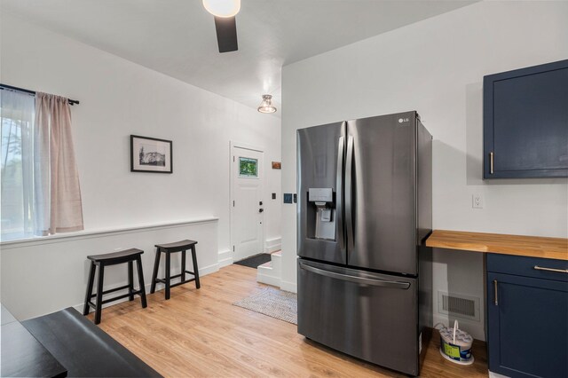 kitchen featuring ceiling fan, visible vents, stainless steel fridge with ice dispenser, and light wood-type flooring