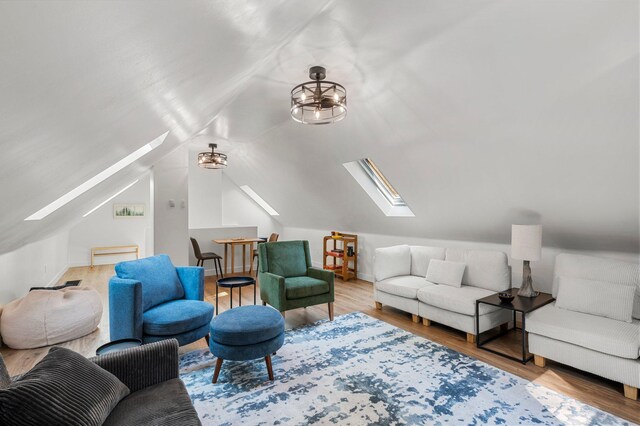 interior space with lofted ceiling with skylight and wood finished floors