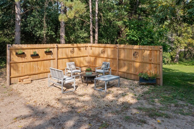 view of yard featuring fence and a fire pit