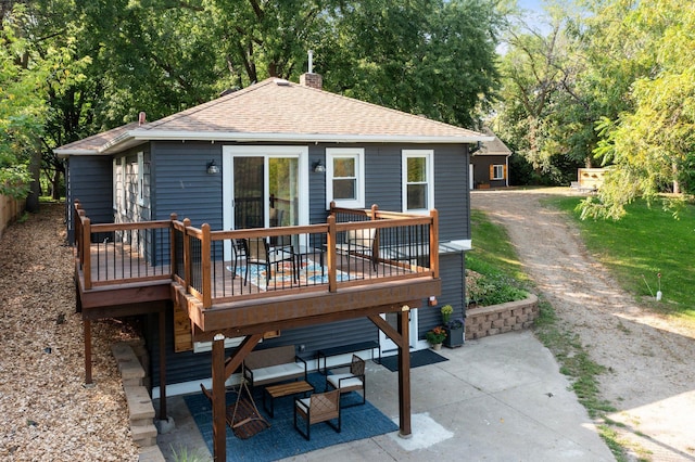 615 Clarence Ave, Minnetrista, MN 55364 - rear view of house featuring a patio, roof with shingles, a chimney, and a deck