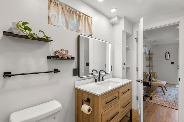 615 Clarence Ave, Minnetrista, MN 55364 - bathroom featuring toilet, wood finished floors, and vanity