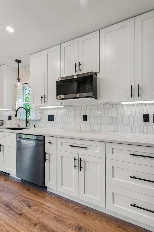 615 Clarence Ave, Minnetrista, MN 55364 - kitchen with a sink, stainless steel appliances, white cabinets, light countertops, and tasteful backsplash
