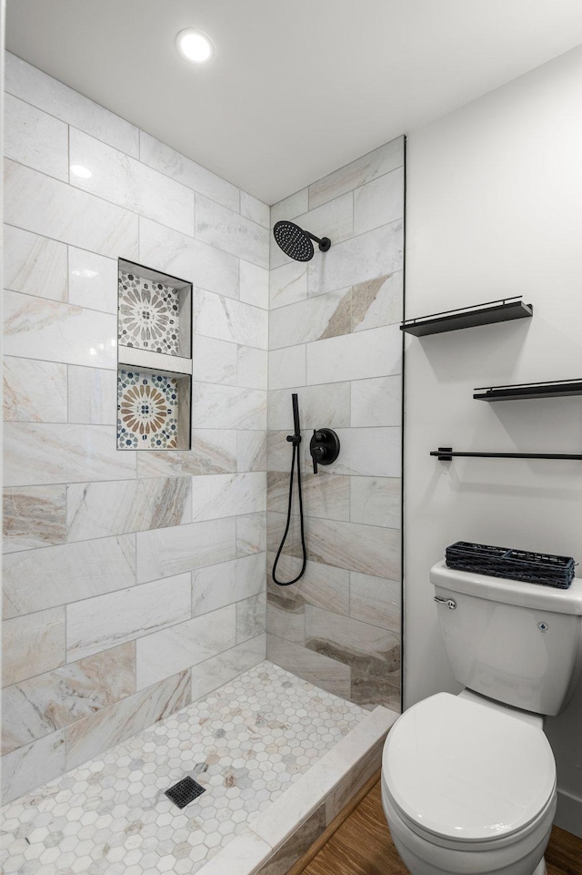615 Clarence Ave, Minnetrista, MN 55364 - full bathroom featuring toilet, a tile shower, recessed lighting, and wood finished floors