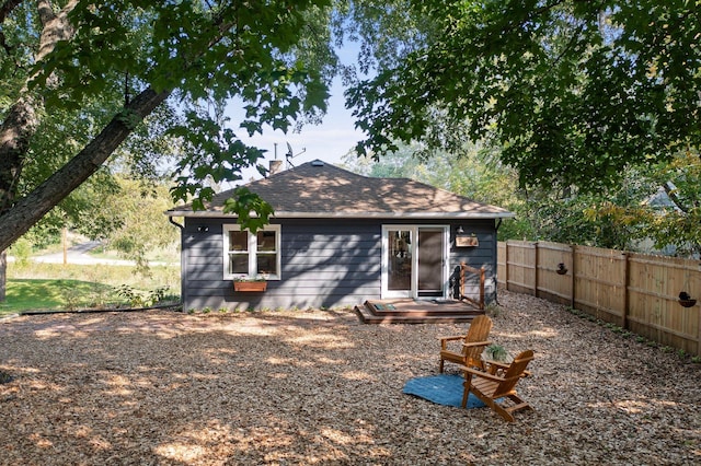 615 Clarence Ave, Minnetrista, MN 55364 - back of house featuring roof with shingles, fence, and a chimney