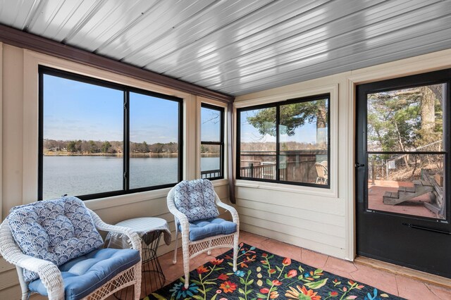 sunroom / solarium with a water view
