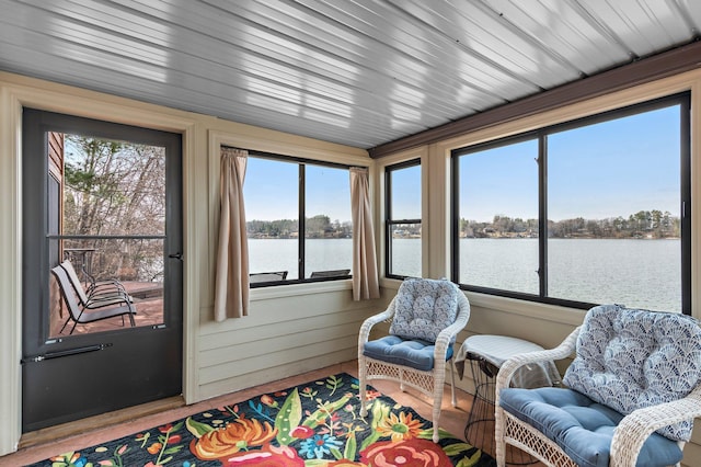 sunroom with a water view and a wealth of natural light
