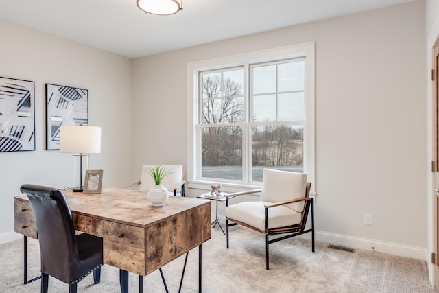 interior space with baseboards, visible vents, and light carpet