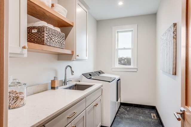 laundry area featuring washing machine and clothes dryer, a sink, visible vents, marble finish floor, and cabinet space