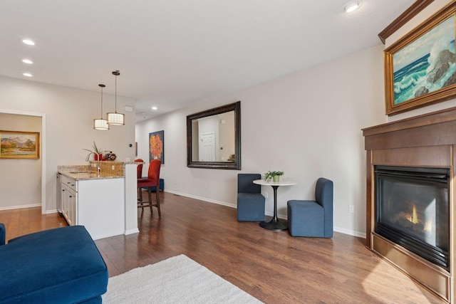 17785 Valley Cove Ct, Minnetonka, MN 55345 - living room featuring dark wood-type flooring, recessed lighting, a glass covered fireplace, and baseboards