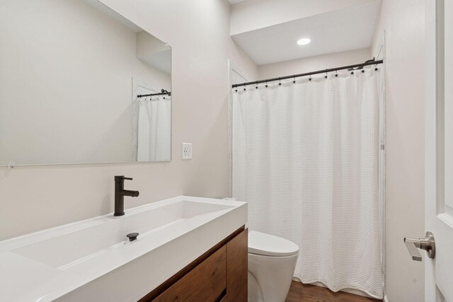 17785 Valley Cove Ct, Minnetonka, MN 55345 - full bath featuring toilet, vanity, wood finished floors, recessed lighting, and curtained shower
