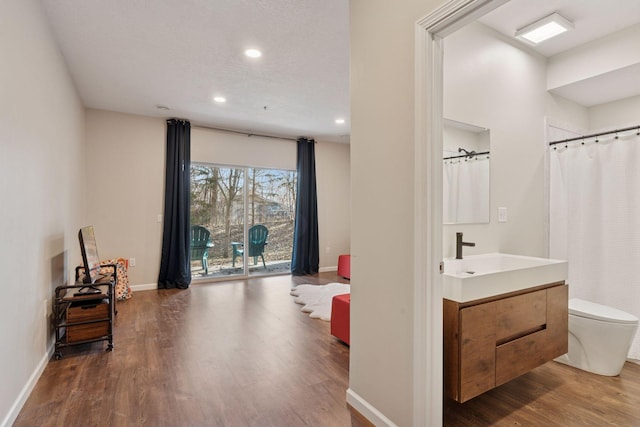 17785 Valley Cove Ct, Minnetonka, MN 55345 - bathroom with toilet, wood finished floors, vanity, recessed lighting, and baseboards