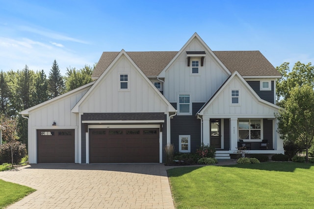view of front facade featuring a porch, a front yard, decorative driveway, and board and batten siding