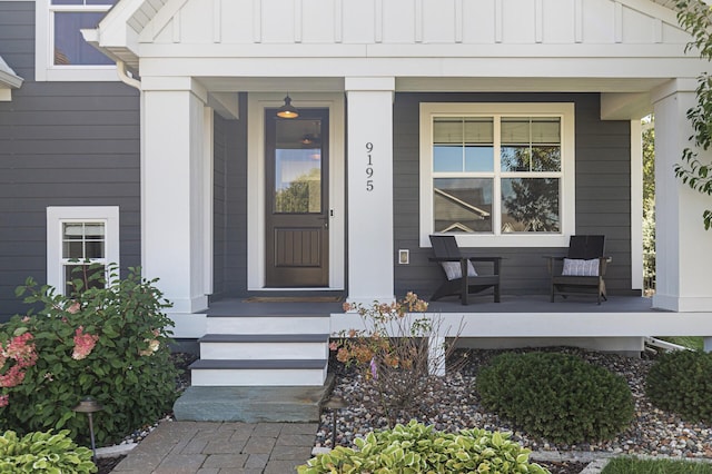 9195 Eagle Ridge Rd, Chanhassen, MN 55317 - view of exterior entry featuring board and batten siding and a porch