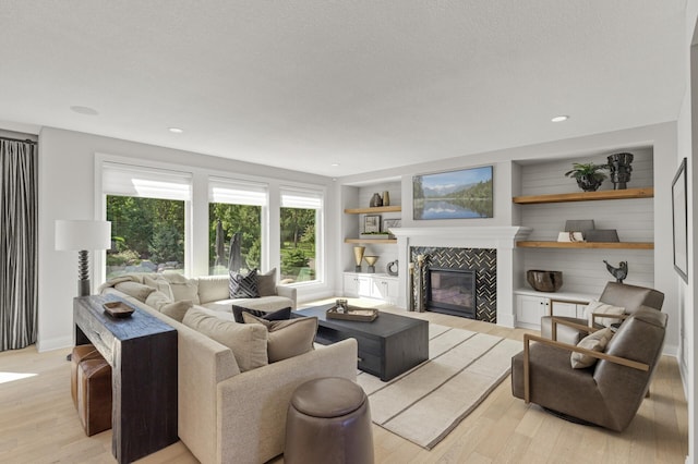 9195 Eagle Ridge Rd, Chanhassen, MN 55317 - living room with light wood-style floors, healthy amount of natural light, a fireplace, baseboards, and recessed lighting