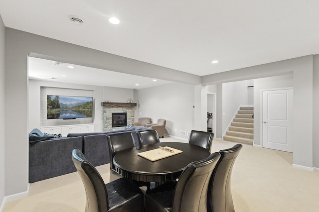 9195 Eagle Ridge Rd, Chanhassen, MN 55317 - dining space with a fireplace, light colored carpet, stairs, recessed lighting, and baseboards