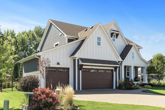 9195 Eagle Ridge Rd, Chanhassen, MN 55317 - modern farmhouse with board and batten siding, roof with shingles, an attached garage, covered porch, and driveway